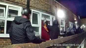 'Sawed open': Dramatic moment police slice front door in dawn raid on suspected knife smuggler's London home
