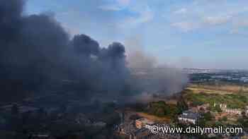 Huge blaze breaks out in London as 125 firefighters rush to battle flames and smoke billows over the capital