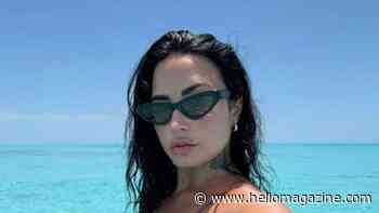 Demi Lovato brings the heat showing off tattoos in tiny string bikini