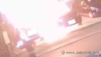 Moment idiot arsonist sets himself on fire as he torches two cars in the middle of the night