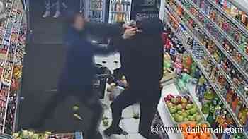 Moment shopper desperately grapples with gunman in London corner shop as he's targeted in 'underworld shooting'