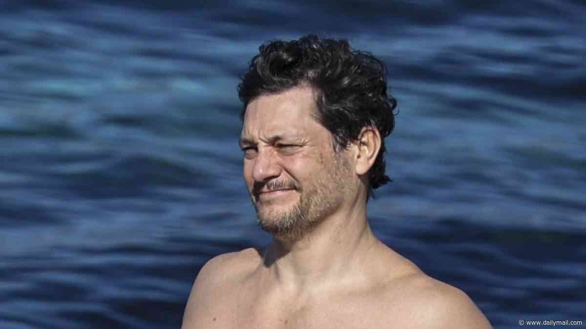 Australian Idol star Rob Mills turns heads at a Sydney beach as he takes a dip in a pair of duck-themed tight Budgy Smugglers