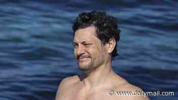 Australian Idol star Rob Mills turns heads at a Sydney beach as he takes a dip in a pair of duck-themed tight Budgy Smugglers