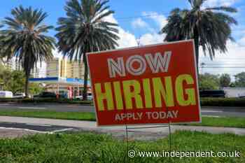US jobless claims slip to 203,000 as layoffs remain low