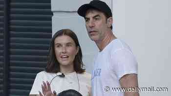 Sacha Baron Cohen turns on the charm as he chats to pretty brunette outside a bar in Notting Hill after the release of new Ali G trailer