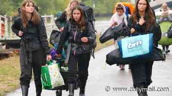 Thousands of revellers brave the rain as they set up camp at Reading festival ahead of Bank Holiday weekend