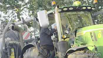 Moment suit-wearing motorist 'attacks' tractor driver in 'road rage row over who should reverse' on narrow country lane