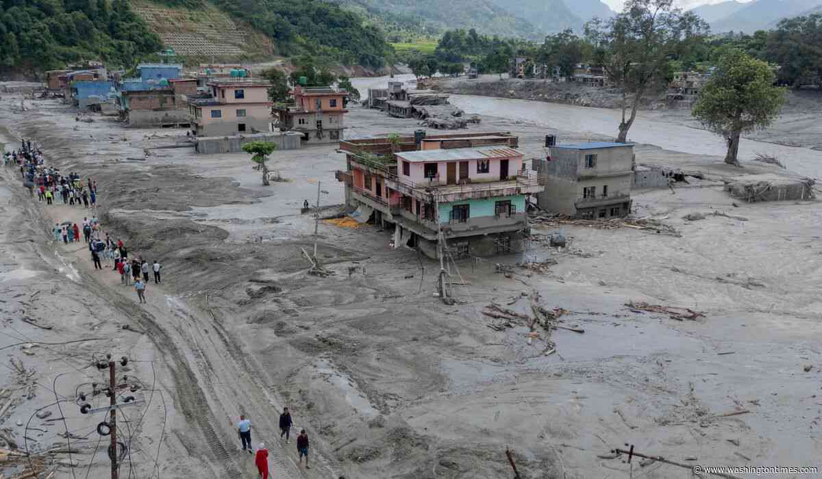 Death toll from floods rises with rescuers in Nepal and China working to find hundreds missing