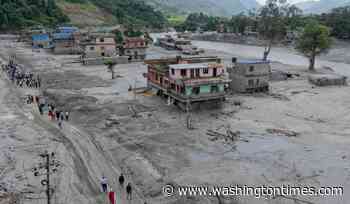 Death toll from floods rises with rescuers in Nepal and China working to find hundreds missing