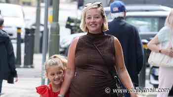 Pregnant Kelsey Parker cradles her bump as her eldest child Aurelia, 6, gives her tummy a little kiss as they spend quality time together ahead of her due date