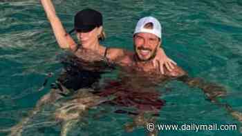 David Beckham shares rare smiling picture of swimsuit-clad wife Victoria frolicking in the sea before passionately kissing during snapshots from their European trip