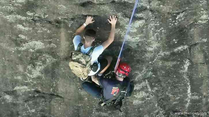 Free climber stranded on Georgia rock face calls 911, prompting dramatic rescue by firefighter