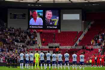 Football fans pay moving tribute to two officers killed in A66 crash