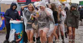Reading Festival fans brave torrential rain and mud bogs as Britain faces horror thunderstorms this weekend