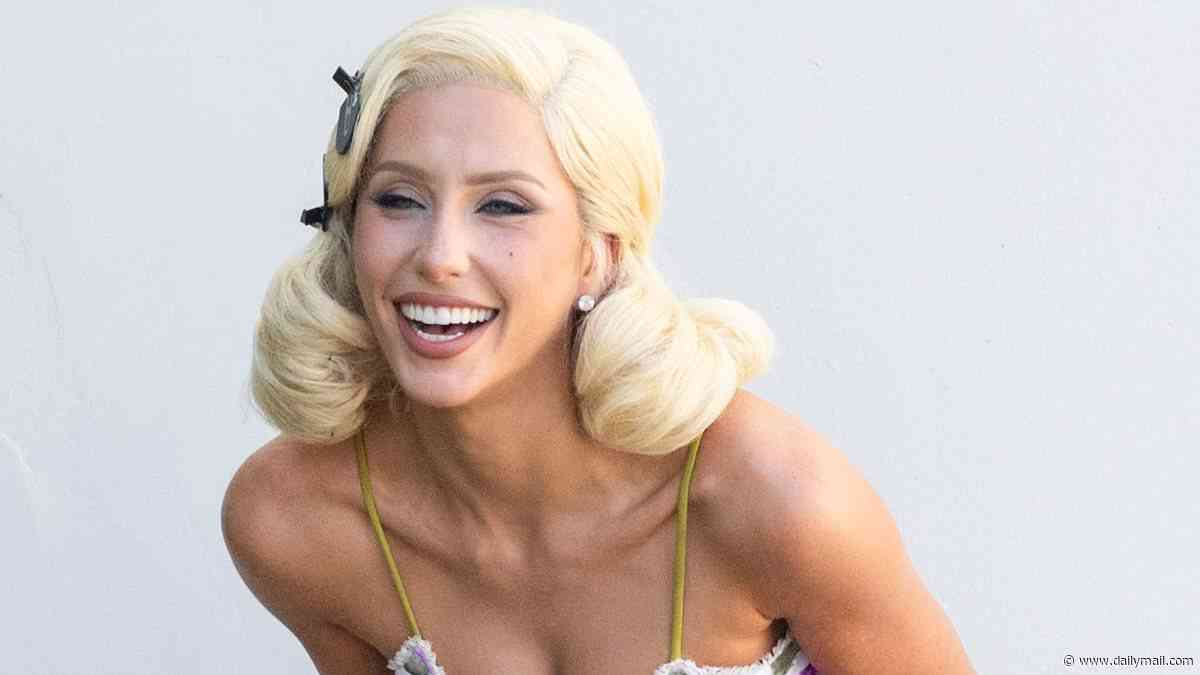 Alix Earle puffs on a cigarette in platinum blonde wig and tiny mini dress during pinup photo shoot