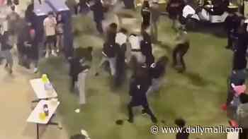 Chaos erupts at high school football game with five arrested after huge fight and gun found....as dramatic footage shows emergency services rushing to area and crowds fleeing
