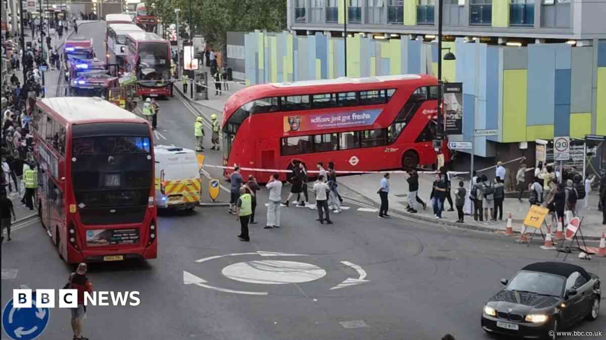 Pedestrian injured as bus crashes into building