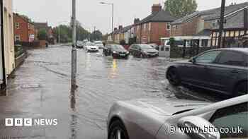 City streets hit by flooding after heavy downpours