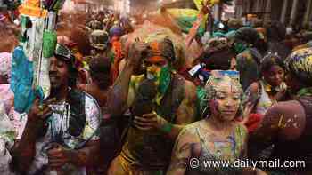 Notting Hill Carnival gets off to colourful start as revellers douse each other with paint in dawn ritual - amid backdrop of mammoth police and security operation