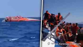 Eerste beelden: mensen op romp van gekapseisd schip