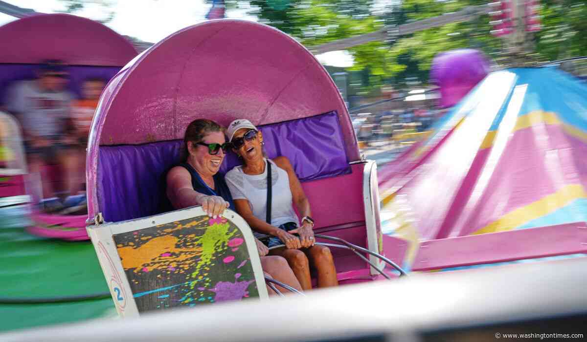 Spinning and dipping, Minnesota fairgoers delight in the classic Tilt-A-Whirl ride as it turns 100