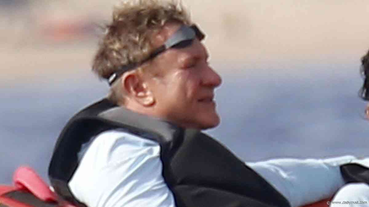 Duran Duran frontman Simon Le Bon, 67, clutches a beer on inflatable boat ride during family holiday with wife Yasmin on luxury yacht in Sardinia