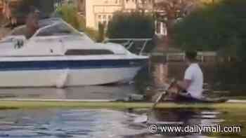 Moment furious speedboat driver 'tries to ram into Olympic rower' on the Thames and threatens him in river rage row