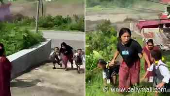 Moment heroic woman rescues two children seconds before rampaging flash floods demolish home in Nepal