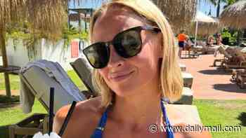 Kimberley Walsh shows off her toned figure in a blue bikini as she sips a frozen cocktail in carefree family snaps from holiday to Spain