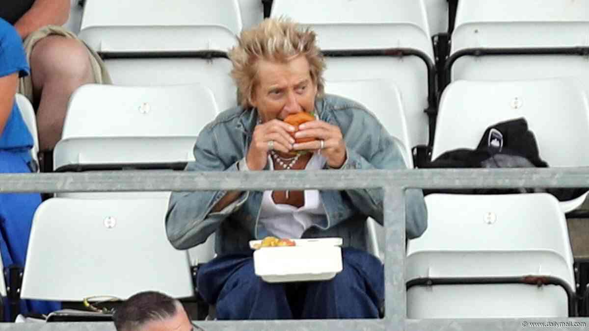 Rod Stewart, 81, tucks into a burger and chips as he watches his local football team with son Alastair, 20, after heart surgery