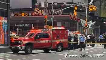 Two people in critical condition after knife-wielding woman stabs them in Times Square - before she is shot by police in front of hundreds of tourists