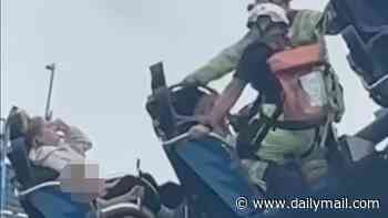 Mother tells of terror after rollercoaster malfunction left her and her young daughters trapped 50ft in the air for HOURS