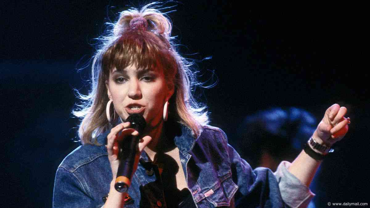 '80s pop icon Debbie Gibson flaunts her incredible figure on stage in a VERY skimpy outfit at age 56