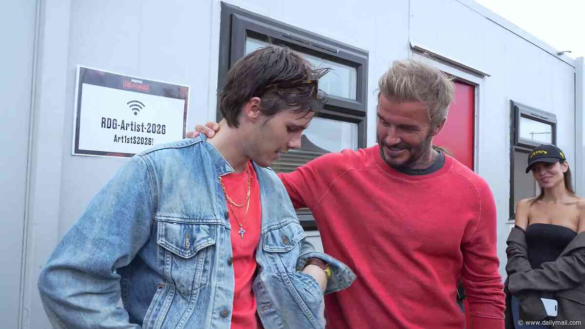 Proud parents David and Victoria Beckham wrap their arms around son Cruz after his 'amazing' Reading gig as his fashion designer mum praises his edgy look in backstage clip