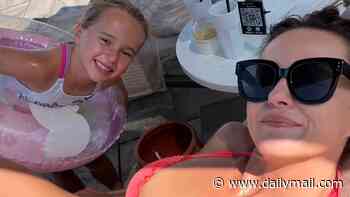 Ola Jordan poses in a hot coral bikini while on holiday with daughter Ella after 'incredibly tough' split from husband James