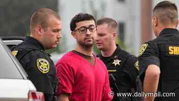 Alleged Penn State cocaine kingpin looks glum as he is handcuffed and carted into court