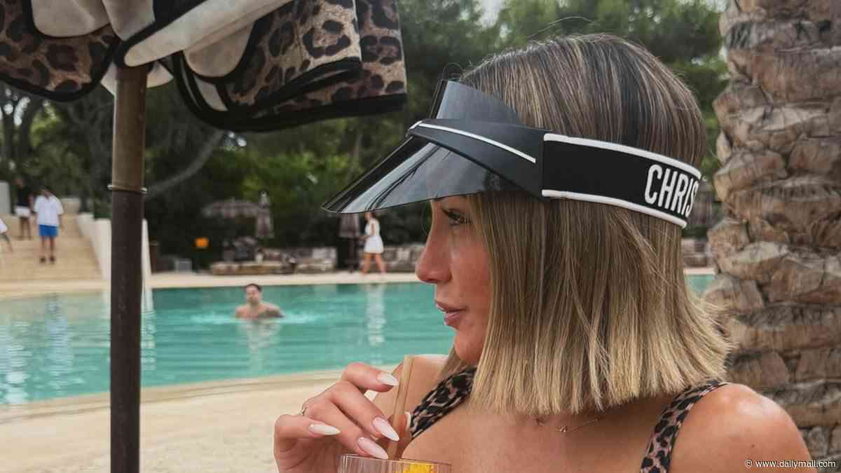 Frankie Bridge shows off her abs in a leopard print bikini and a Dior visor while sipping on cocktails and pose up a storm on Ibiza girls' trip