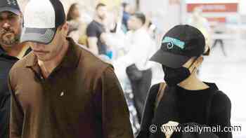 Ariana Grande and boyfriend Ricky Alvarez hold hands as they land back in New York after she bid a tearful farewell to fans while concluding her sold-out UK tour ahead of break