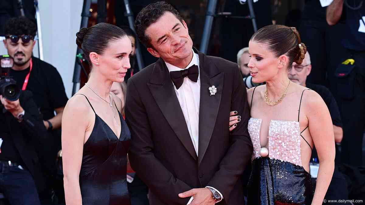 Sisters Rooney and Kate Mara pose with onscreen lover Orlando Bloom at the Bucking Fastard premiere in Venice as they play identical twins who spoke in unison and loved the same man