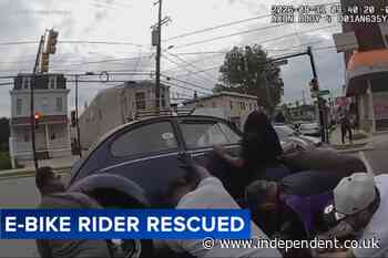 Moment Good Samaritans lift a car to free e-bike rider trapped underneath