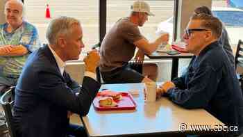 Prime Minister, Bryan Adams dishing over doughnuts in Thunder Bay