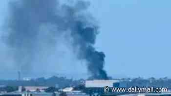 Woman fighting for life after forklift explodes into flames in Brisbane - as four others are rushed to hospital