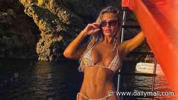 Christine McGuinness poses in her bikini on a pedalo boat on holiday as she escapes the London rain