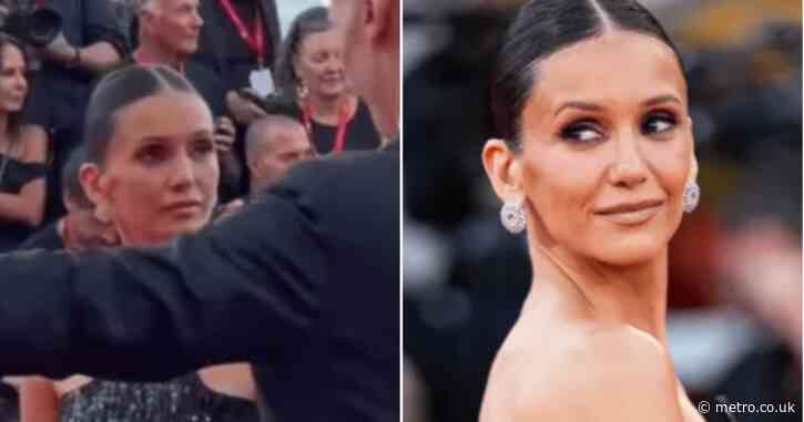 Nina Dobrev laughs awkwardly after Venice red carpet security make her move