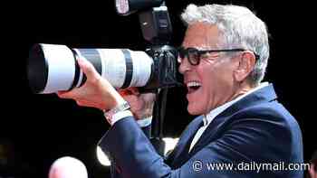 George Clooney cheekily plays photographer on the Venice Film Festival red carpet as his film Furies receives rave reviews from critics