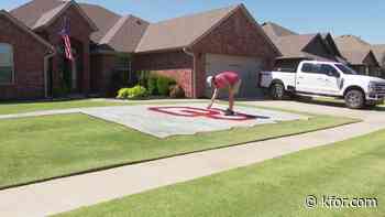 Moore man takes team spirit to new level, paints yard ahead of opening kickoff