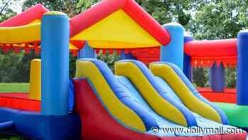 Two children on inflatable jumping castle are rushed to hospital after strong winds lifted it into the air