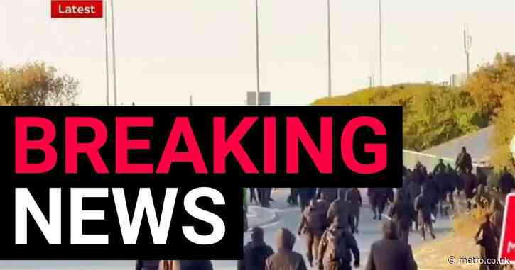 Hundreds of masked people in balaclavas halt traffic in Dover as part of protest