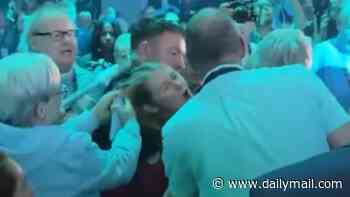 Reform's Zia Yusuf condemns party members who pulled heckler's hair during Nigel Farage's keynote speech as police urge woman to come forward