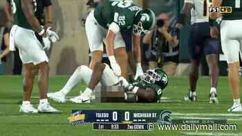 Humiliating moment college football star is caught with his pants down on live TV after opponent's bruising tackle